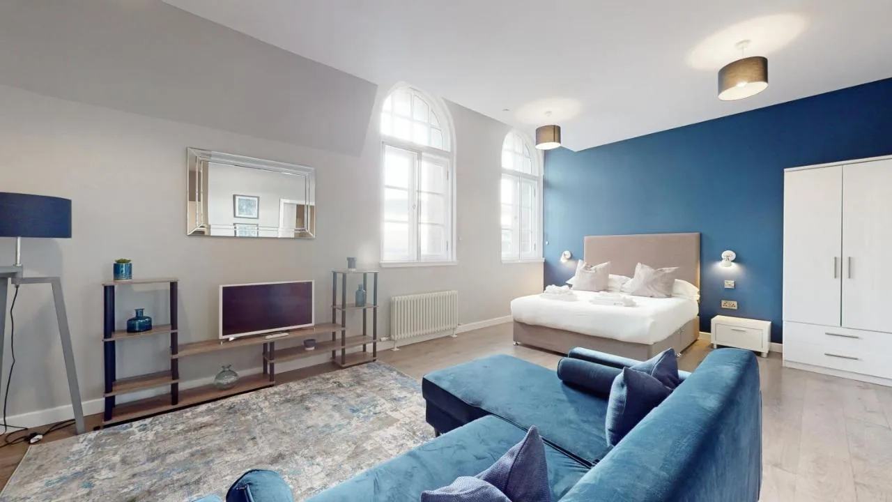 A living room with a couch and a bed at Glassford Residence in Glasgow