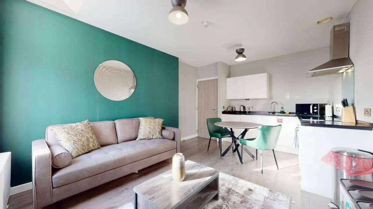 A living room with a couch and a table at Glassford Residence in Glasgow