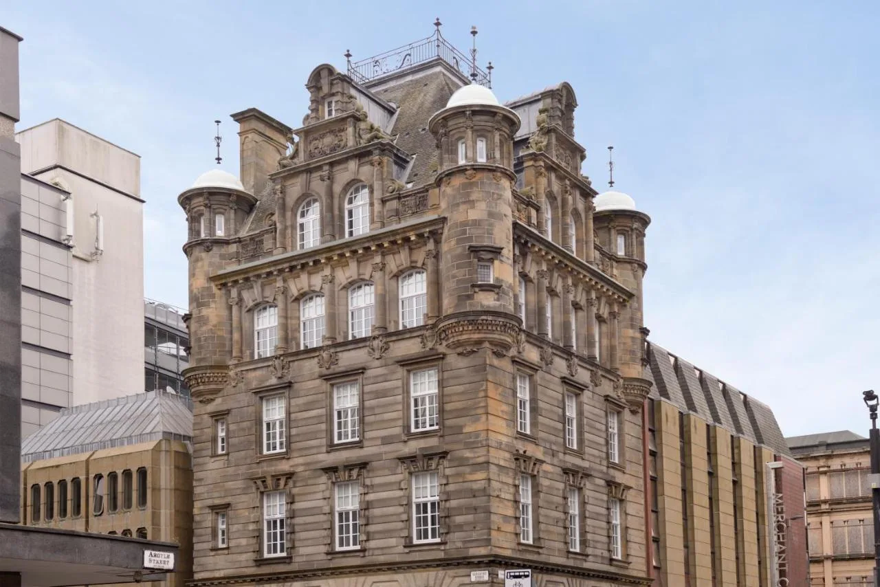 An old brick building on a city street, home to Glassford Residence in Glasgow