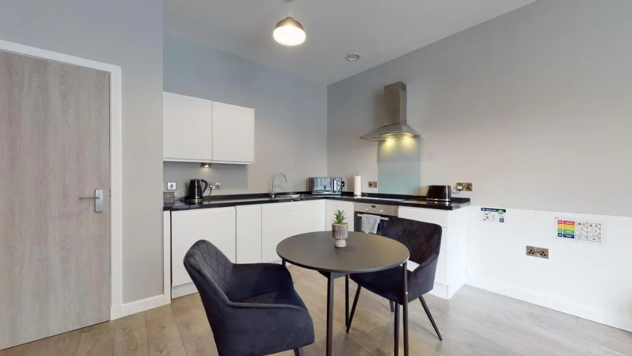 A kitchen with a table and chairs at Glassford Residence in Glasgow